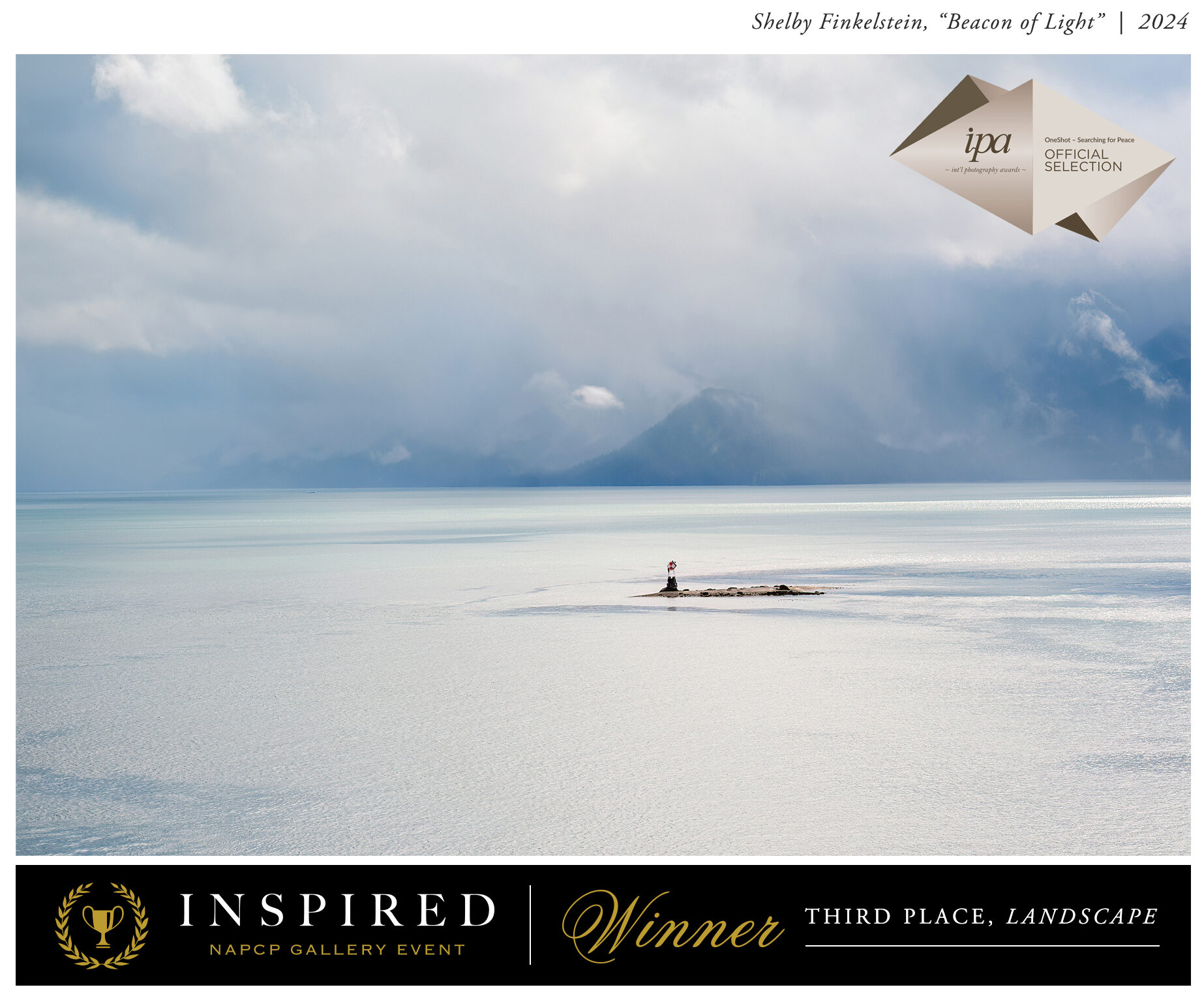 A peaceful landscape of a lighthouse standing on a rock surrounded by water, earning third place in the NAPCP Inspired Image Competition.