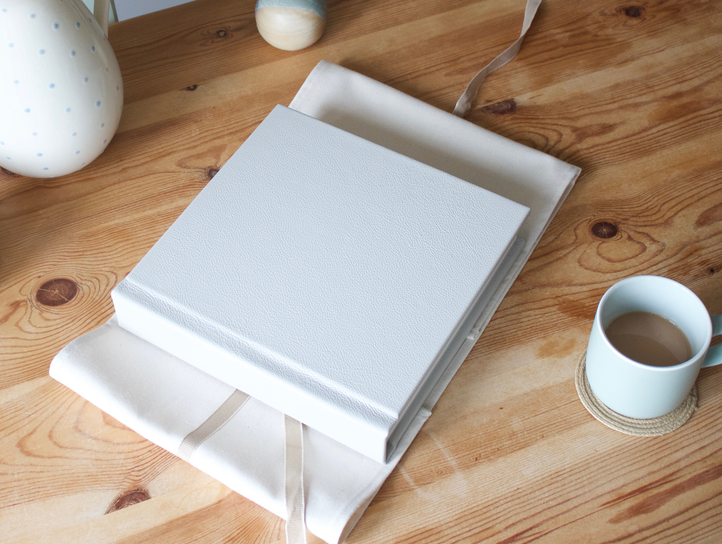 A bespoke photo album resting on a coffee table, perfect for displaying cherished memories.