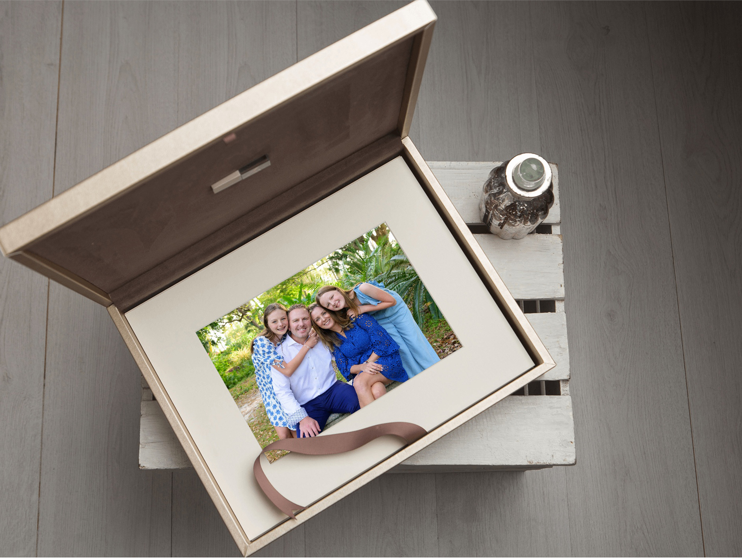 A custom-designed photo folio box featuring a family portrait by Simply Shelby Photography.