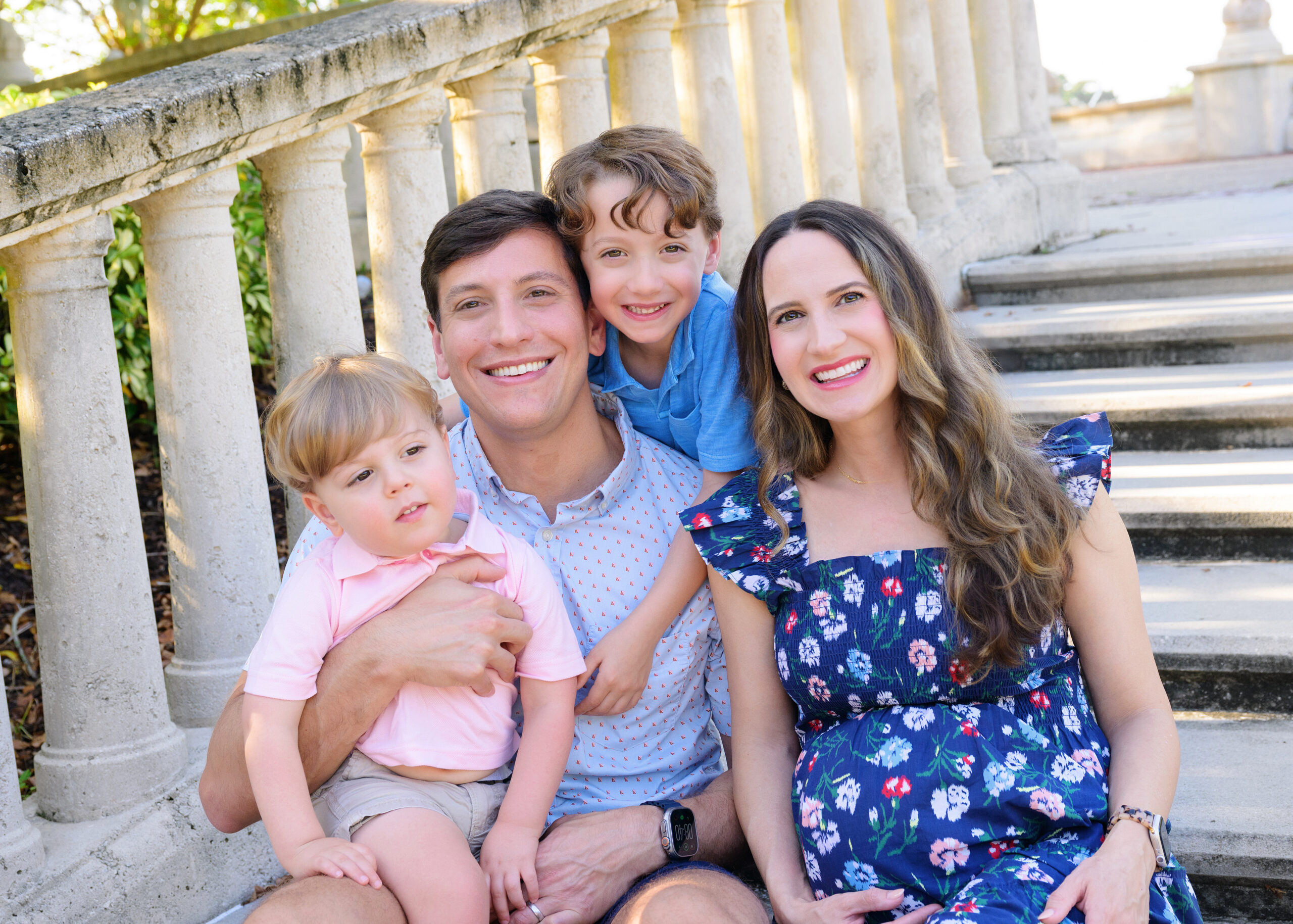 Family of four smiling on outdoor steps in Orlando